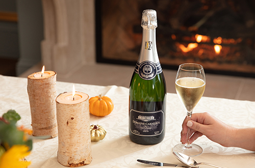 brut by fireplace with pumpkins on table