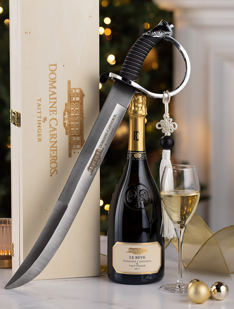 Le Reve bottle with Domaine Carneros Saber and Christmas Tree background