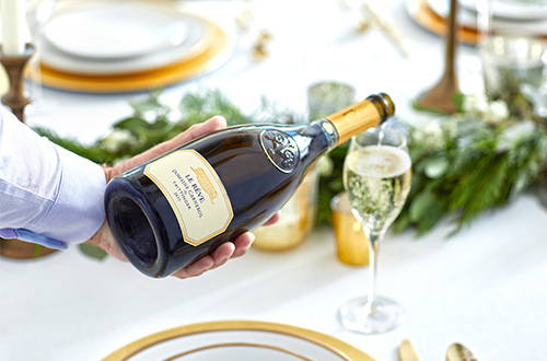 Bottle of Le Reve in front of Fireplace 