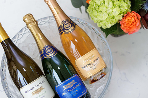 Ice bucket with Chardonnay, Brut, and Rose, with flowers