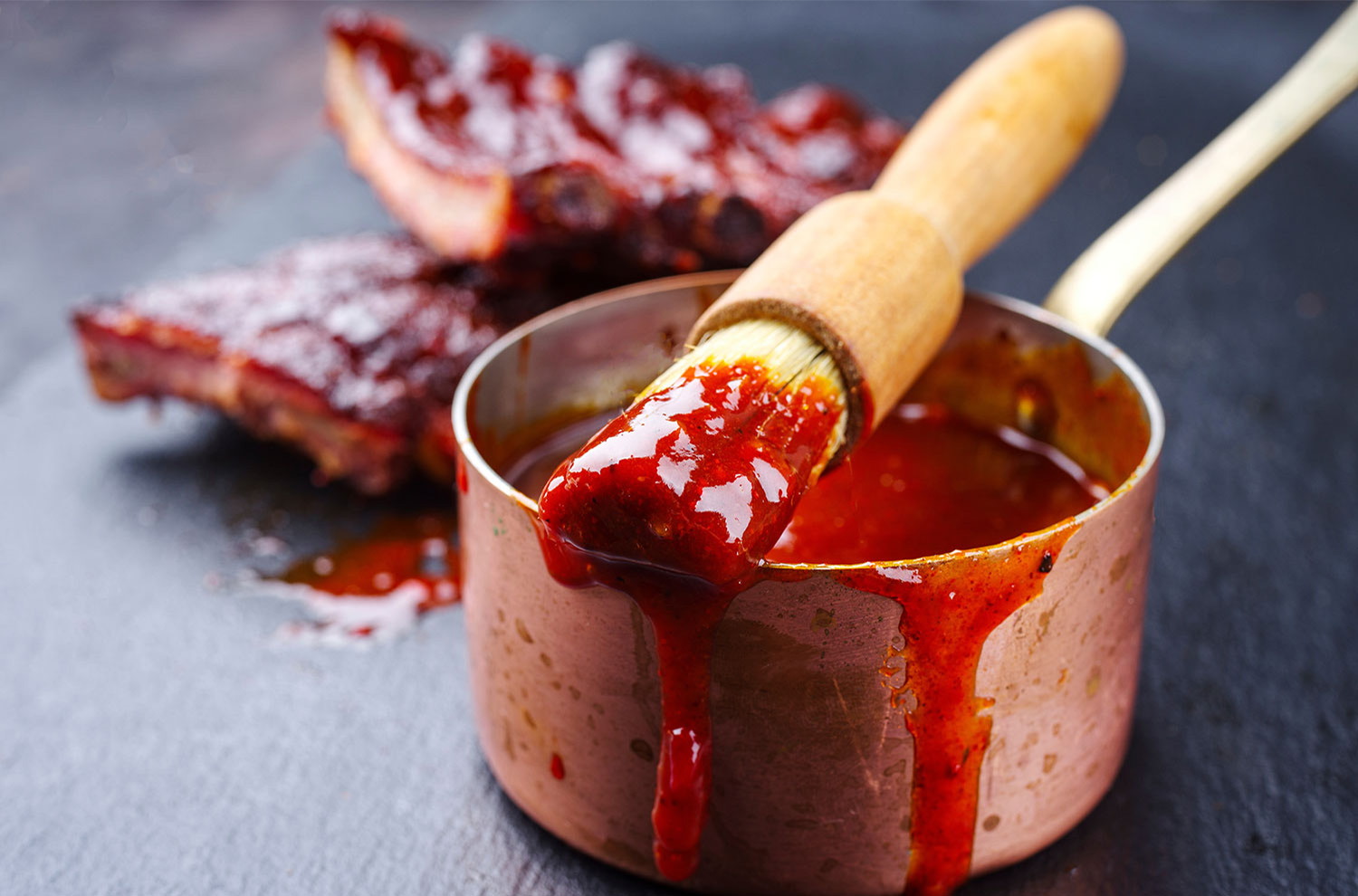 bowl of honey sriracha glaze and a culinary crush