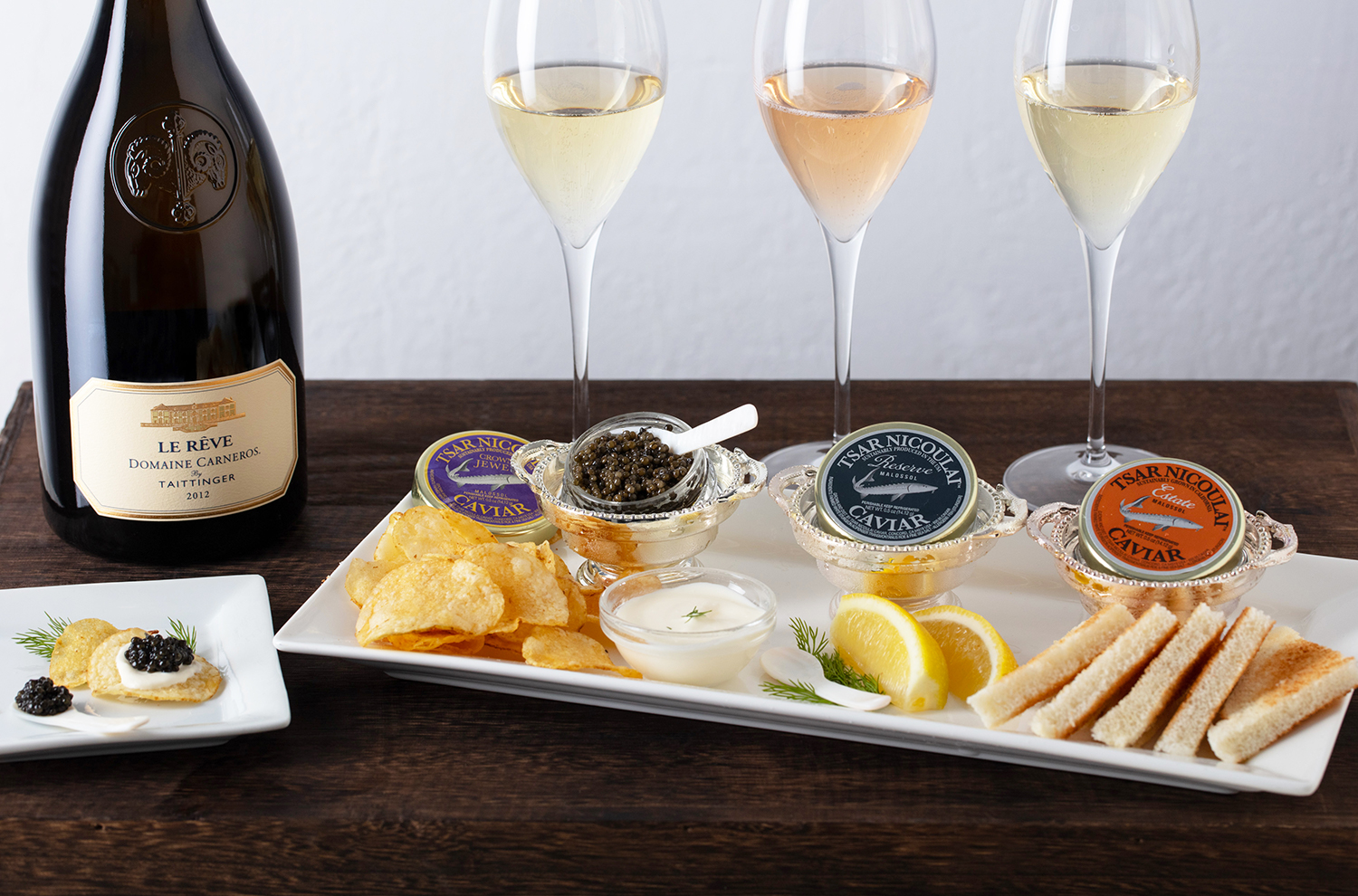 jars of caviar with glasses of sparkling wine