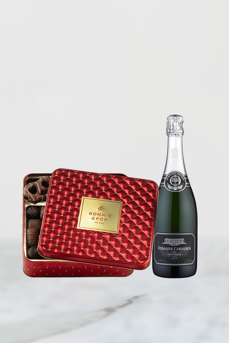 Bottle of Blanc de Noir with a festive tin of nuts and chocolates from Bonnie & Pop