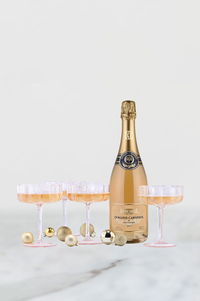 bottle of Brut Rose with four pink petal coupes