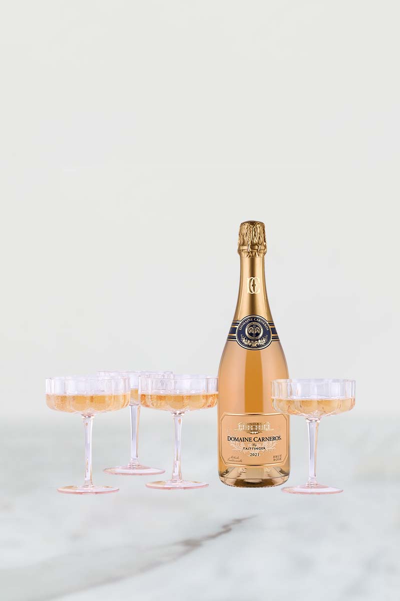 bottle of Brut Rose with four pink petal coupes