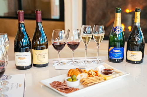 Wine tasting flight in front of fireplace with cheese and charcuterie board