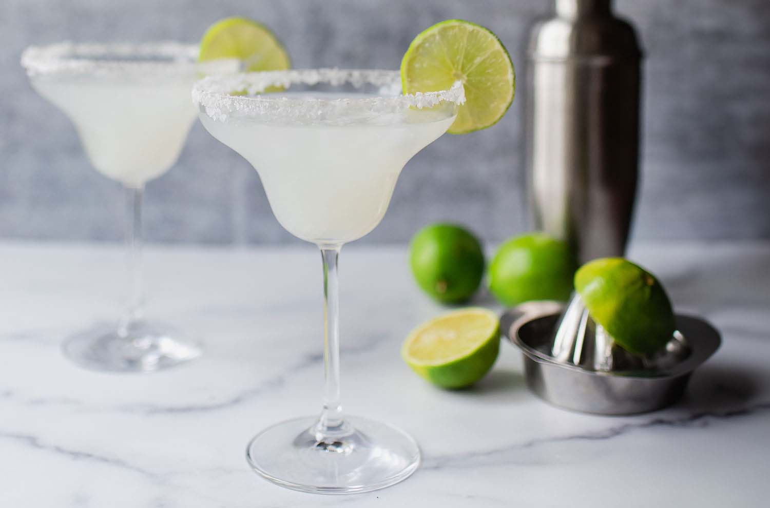 coupes of sparkling margaritas with limes