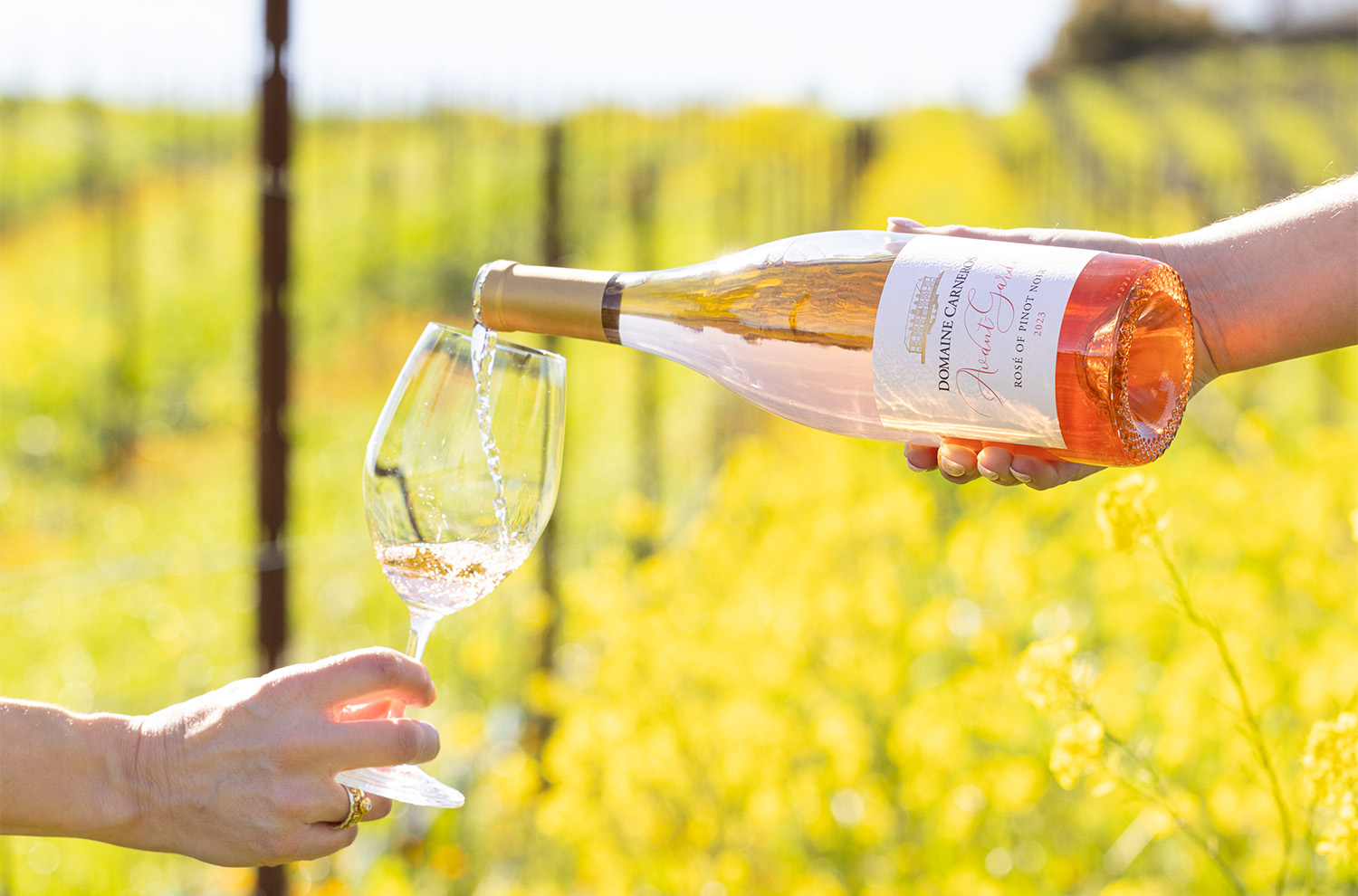Rose glass being poured in floral vineyard