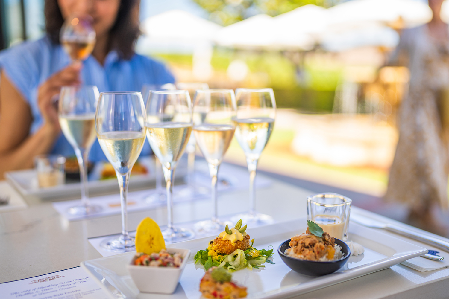 four sparkling flutes and a plate of five bites