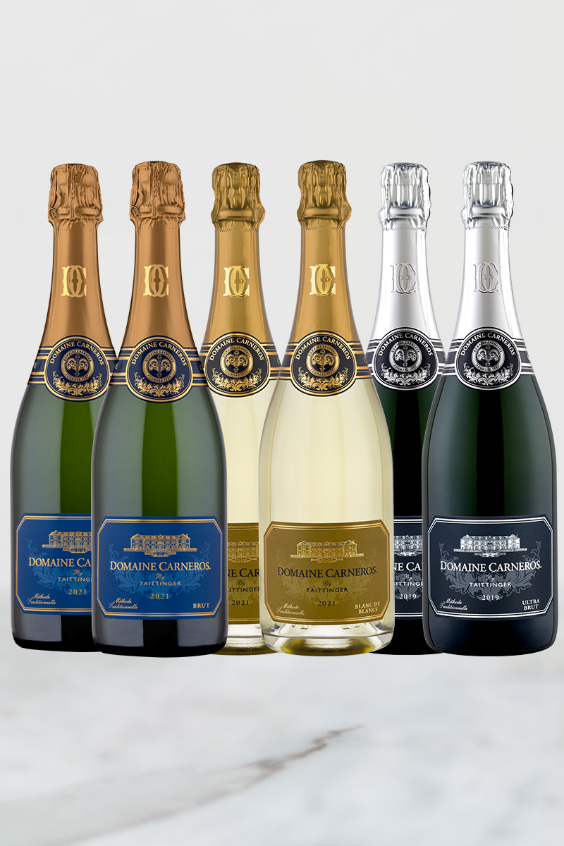 Bottles of 2019 Ultra Brut, 2021 Estate Brut, 2021 Blanc de Blancs on marble