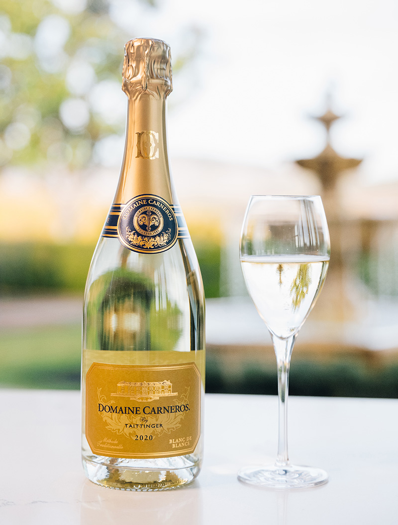 Blanc de Blanc with flute on table with Fountain in background