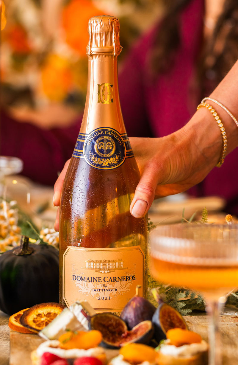 Blanc de Blanc with flute on table with Fountain in background