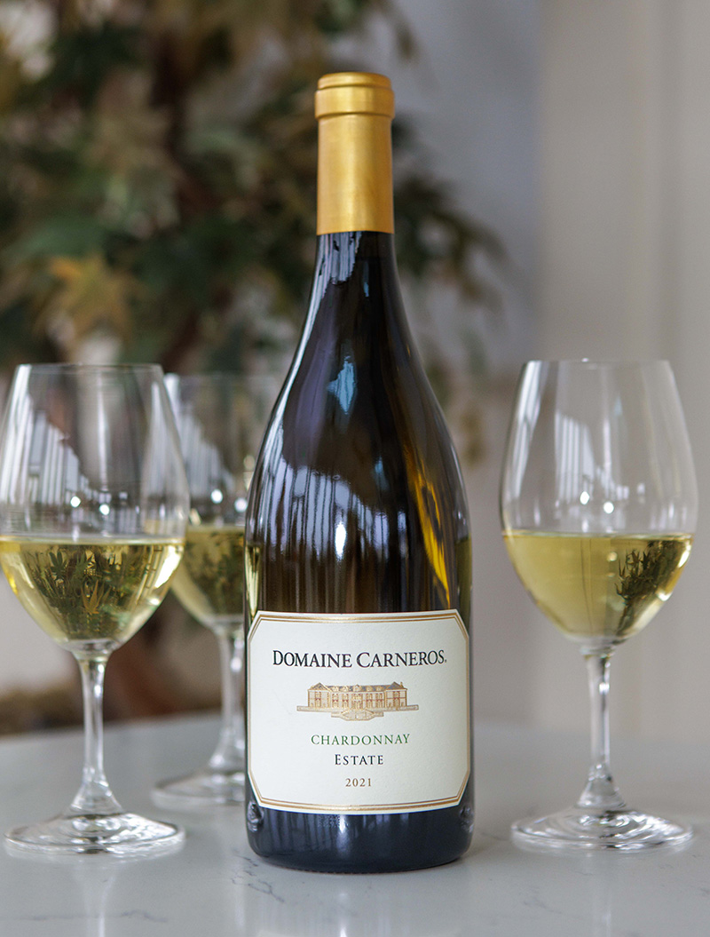 bottle of Estate Chardonnay with glasses on marble table