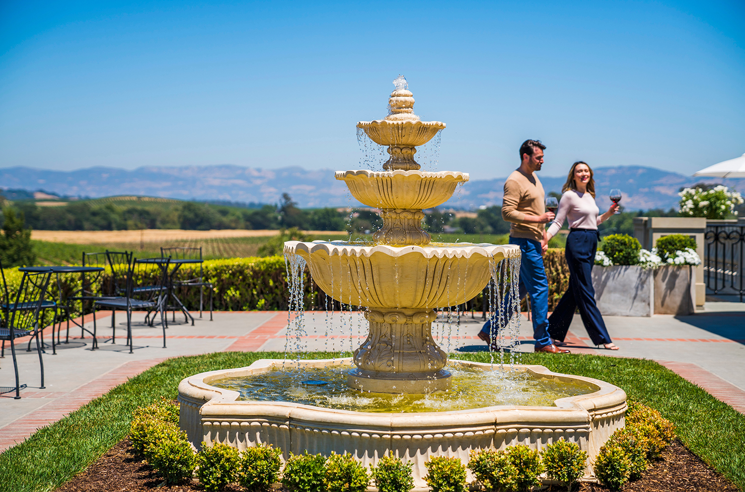 Couple walking on terrace near fountain